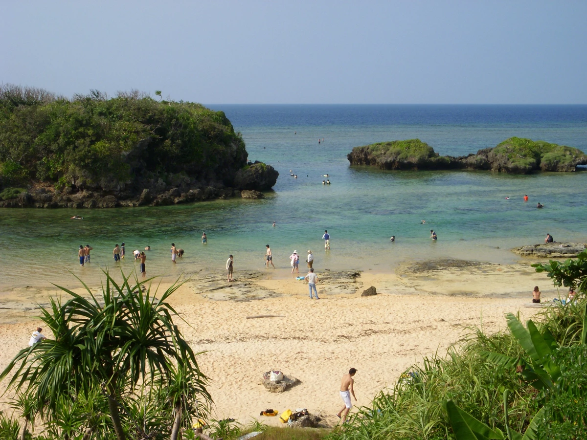 A view over a sandy beach and clear blue water on Iriomote Island, Okinawa, Japan