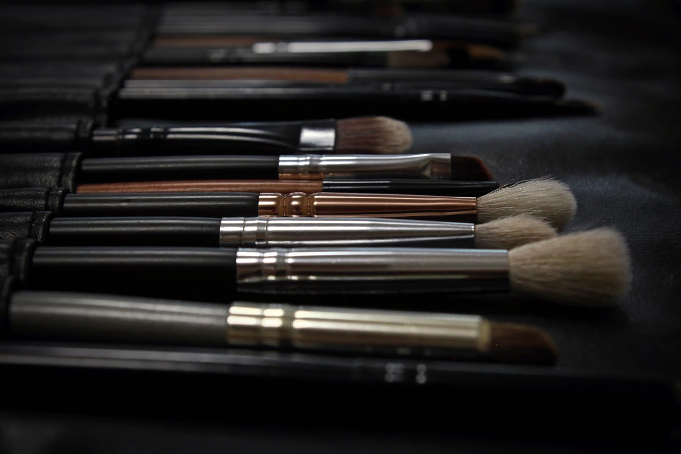 Various makeup brushes lined-up in a salon