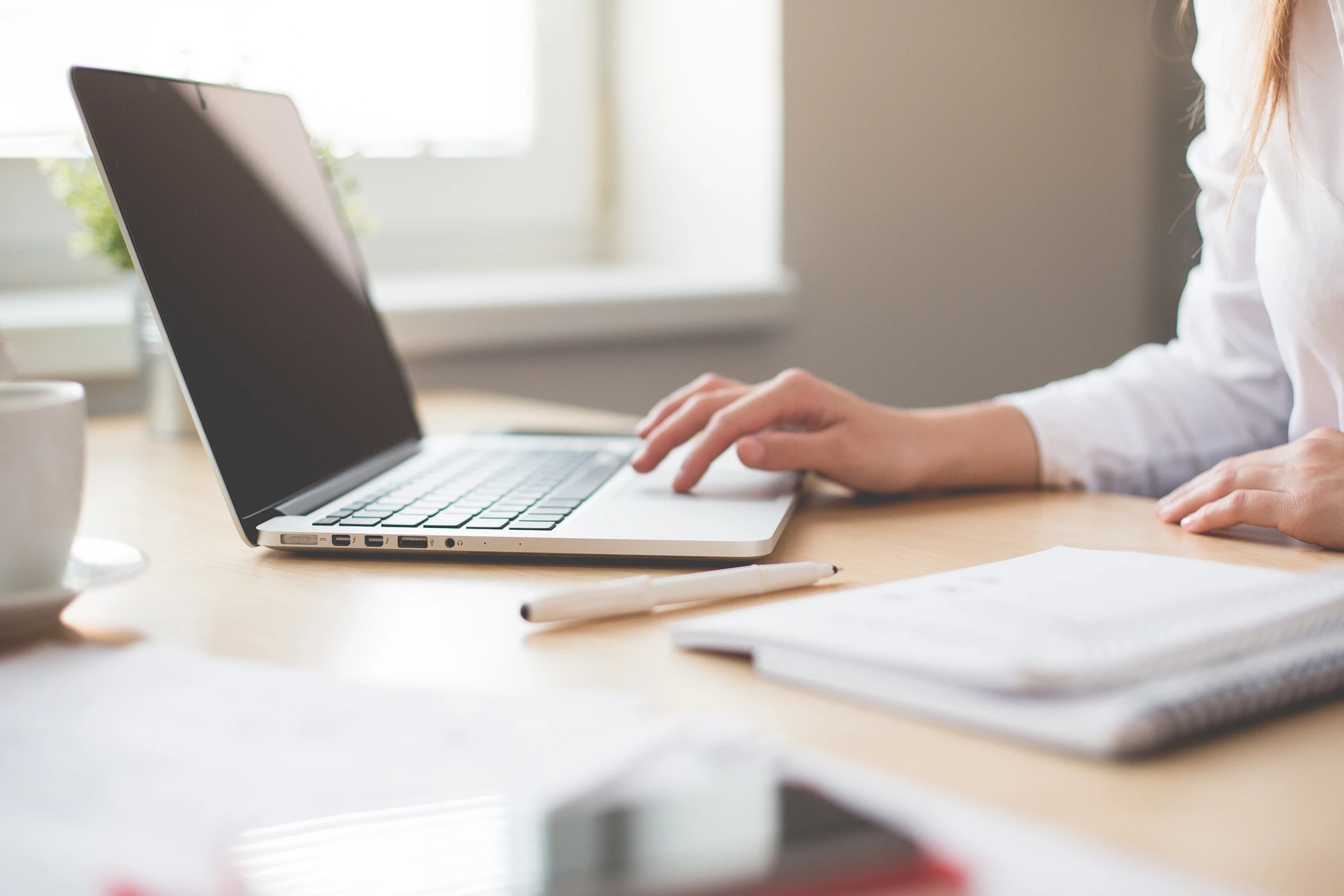 A person at a desk at home on their laptop