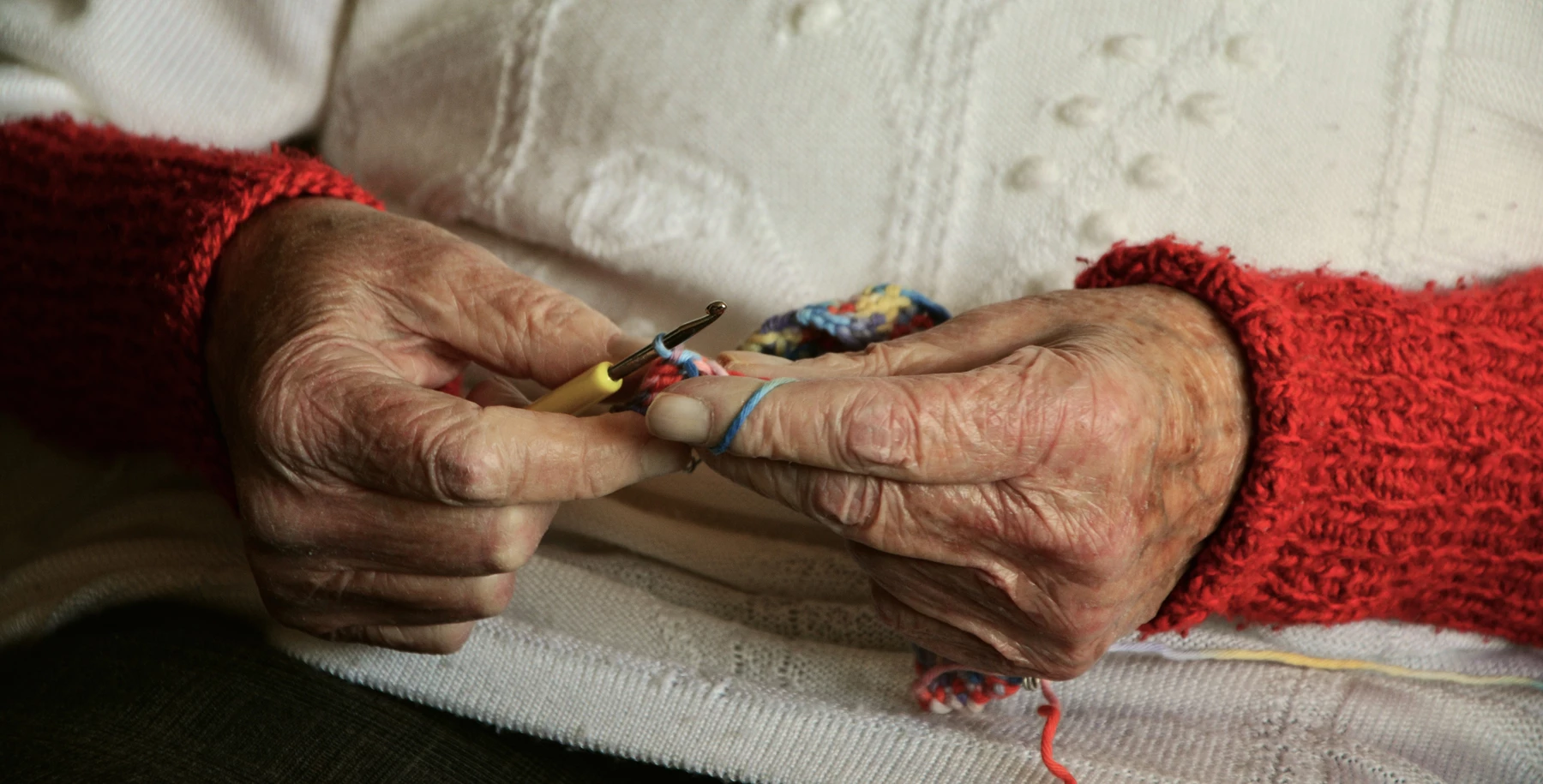 An elderly person knitting