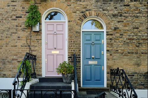 a house with a pink and blue door